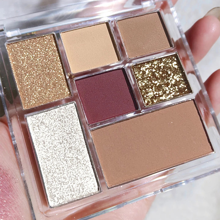 Seven-color eyeshadow palette in earth tones with shimmer, glitter, matte, and pearl finishes, waterproof, and playful
